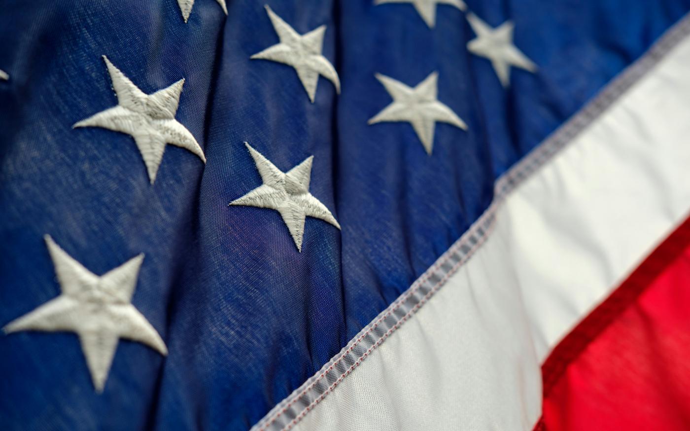 blue, white, and red flag by Luke Michael courtesy of Unsplash.