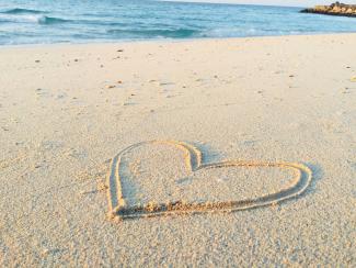 heart drawn on sand during daytime by Khadeeja Yasser courtesy of Unsplash.