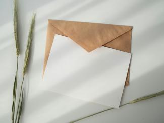 white paper and brown envelope by Kate Macate courtesy of Unsplash.