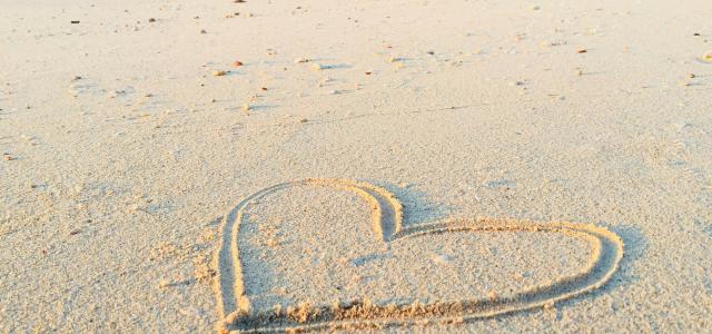 heart drawn on sand during daytime by Khadeeja Yasser courtesy of Unsplash.