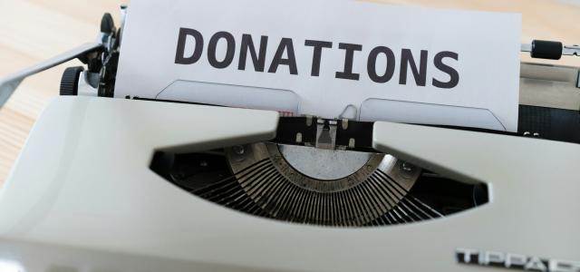 a close up of a typewriter with a donation sign on it by Markus Winkler courtesy of Unsplash.